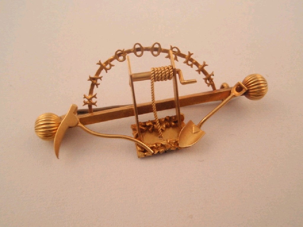 Appraisal: An Australian goldminer brooch with attached pick spade winder and