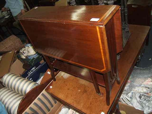 Appraisal: A MAHOGANY SUTHERLAND TABLE with satinwood and ebony banded decoration