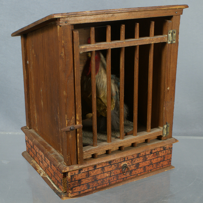 Appraisal: Pine and paper litho chicken in a cage squeak toy