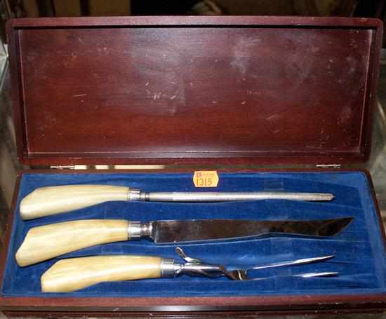 Appraisal: Celluloid handled three-piece carving set in fitted wood case Estimate