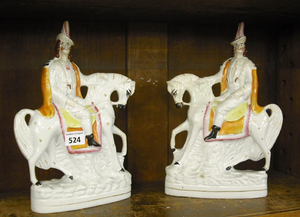 Appraisal: Pair of Staffordshire equestrian figures modelled with soldiers wearing pink