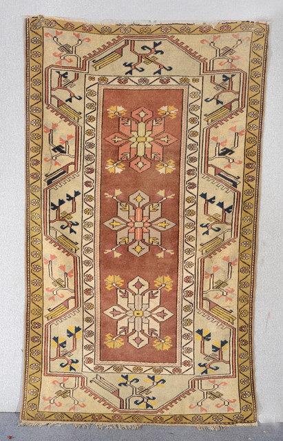 Appraisal: A MELAS BROWN GROUND RUG with medallion and geometric decoration