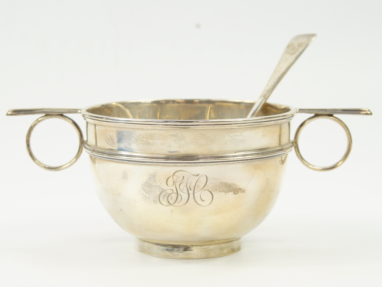 Appraisal: A George V silver twin handled bowl and spoon monogram