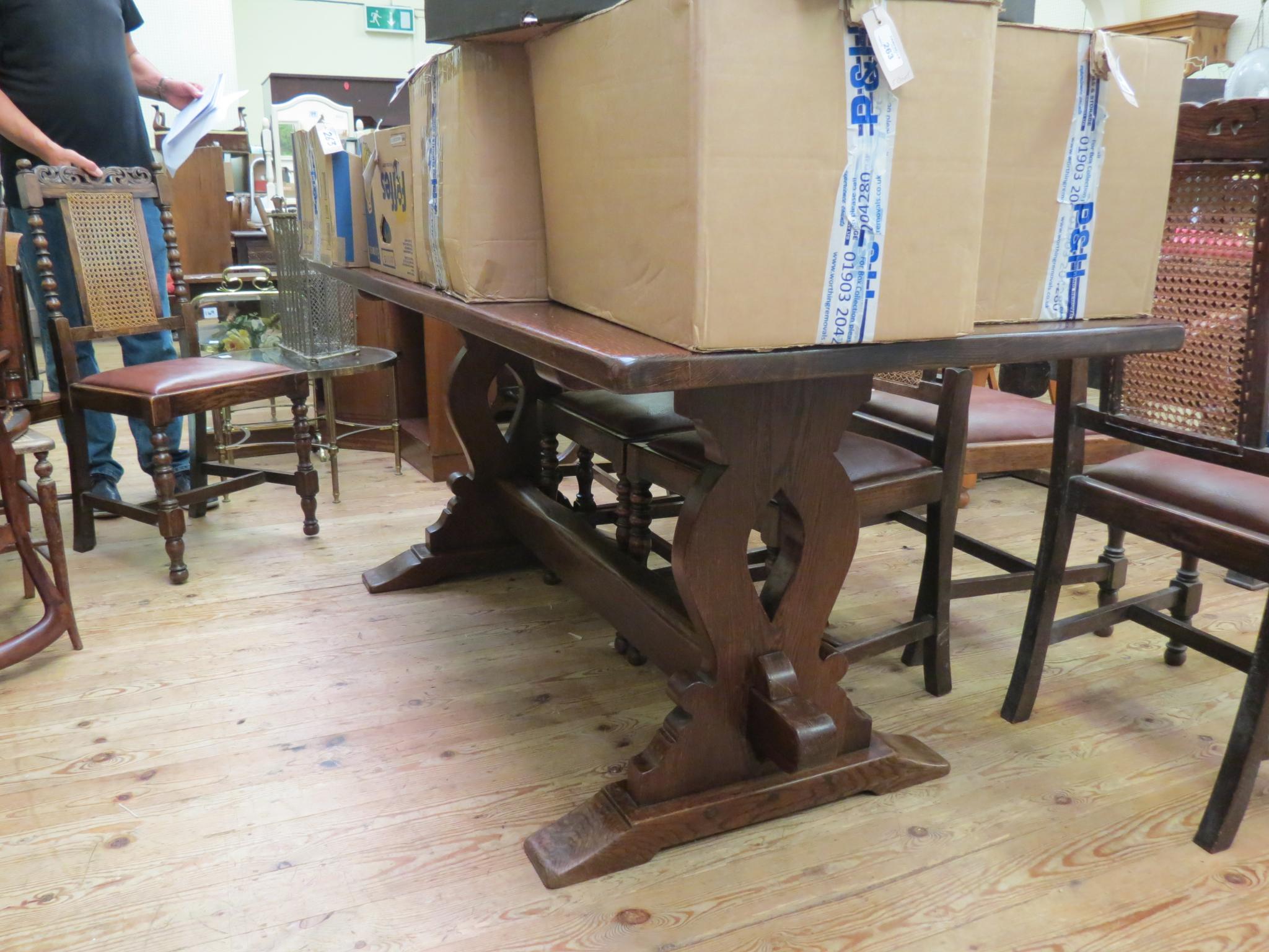 Appraisal: A solid dark oak refectory-type dining table on shaped end