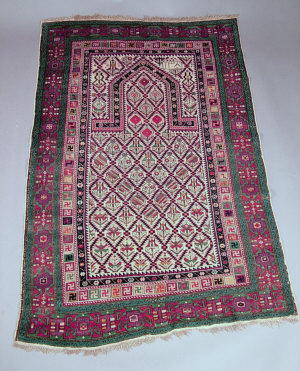 Appraisal: A Shirvan prayer rug with trellis design in an ivory