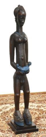 Appraisal: Baule female carved wood figure holding a baby dark wood