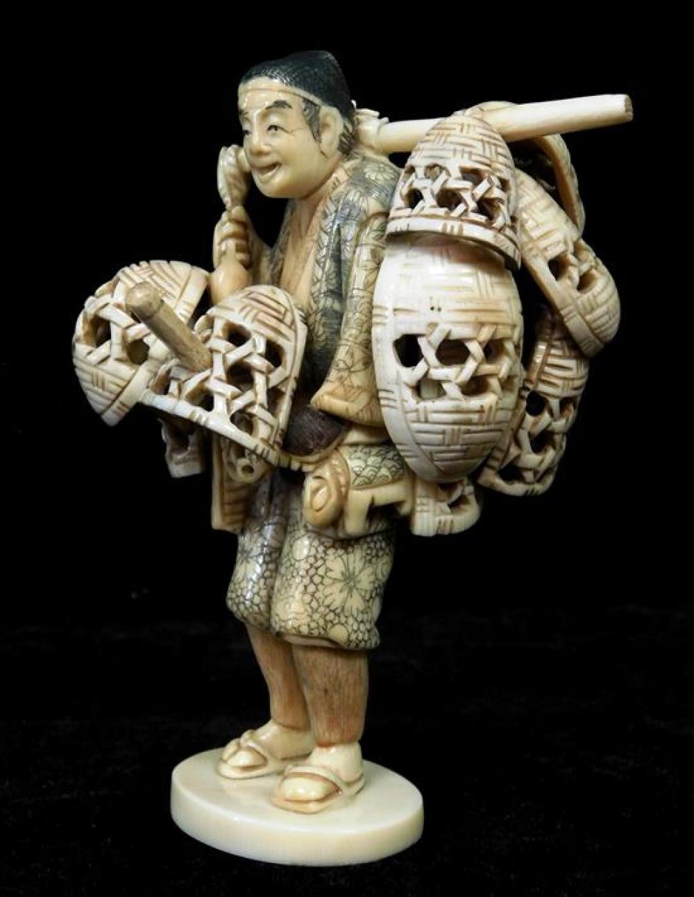 Appraisal: ASIAN Ivory sculpture of man standing with baskets Japanese late