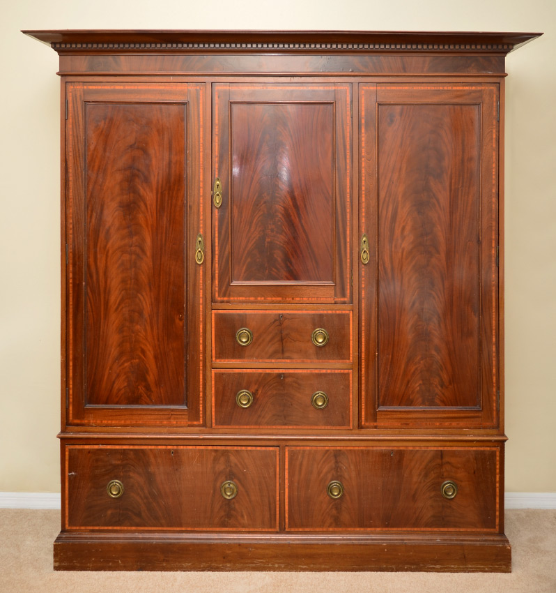 Appraisal: EDWARDIAN MAHOGANY GENTLEMAN'S ARMOIRE Exaggerated cornice pediment over dentil molding