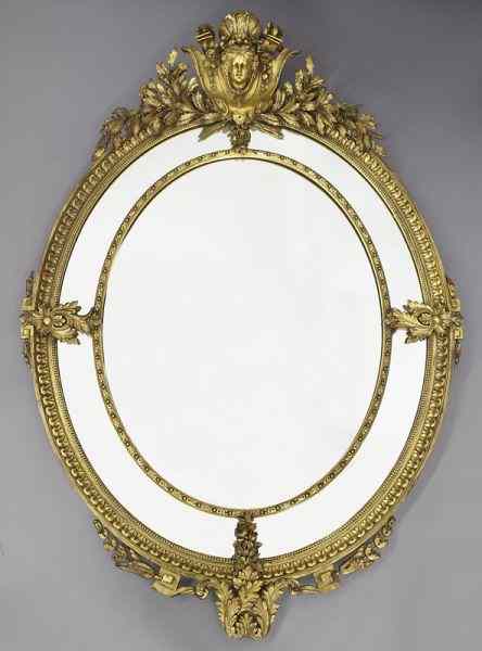 Appraisal: Louis XVI style oval carved gilt mirrorsurmounted by a shell