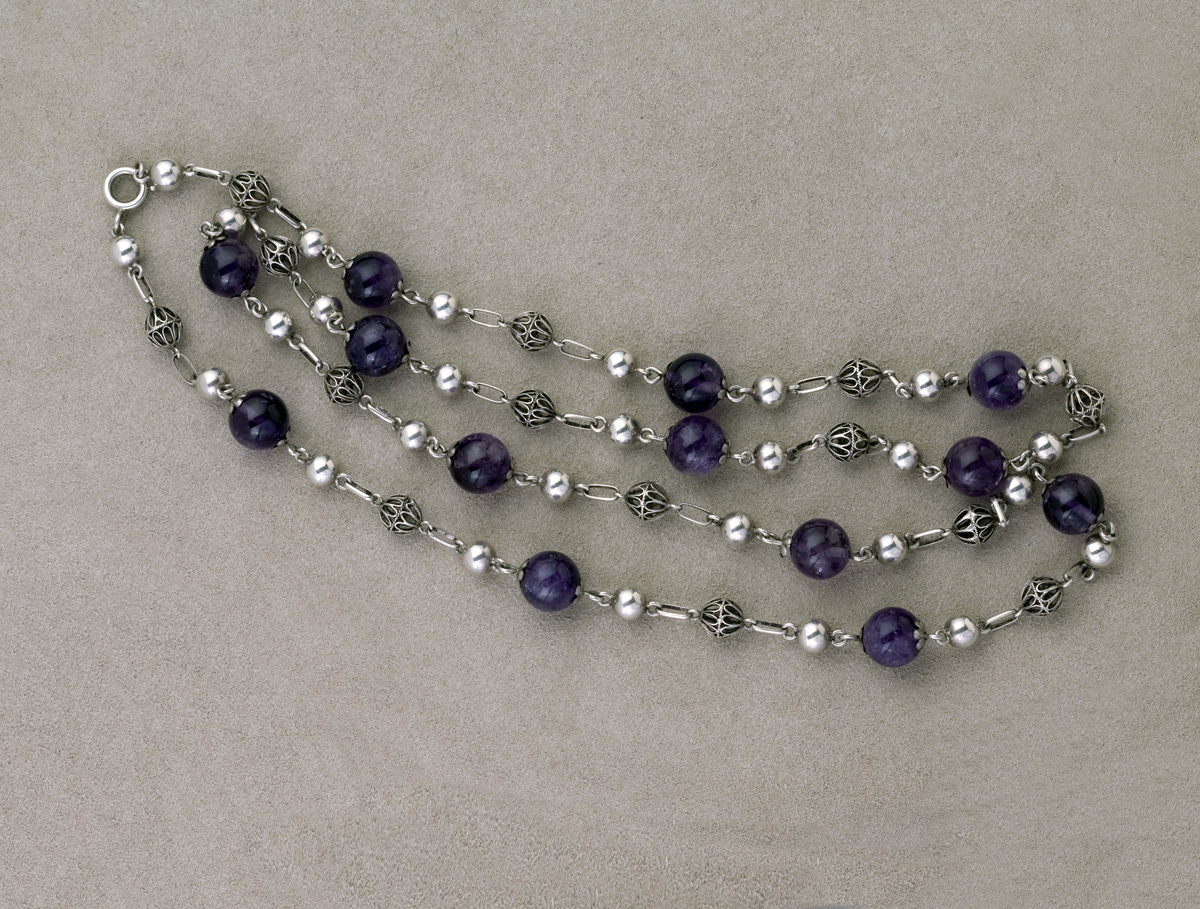 Appraisal: A STRAND OF PERSIAN BEADS Amethyst beads alternating with silver