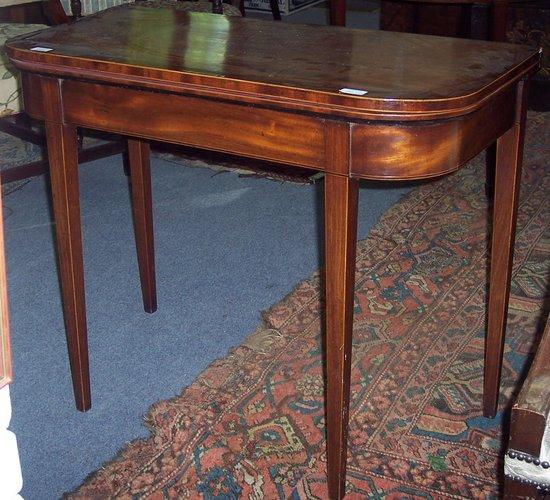 Appraisal: A George III mahogany card table the folding top crossbanded