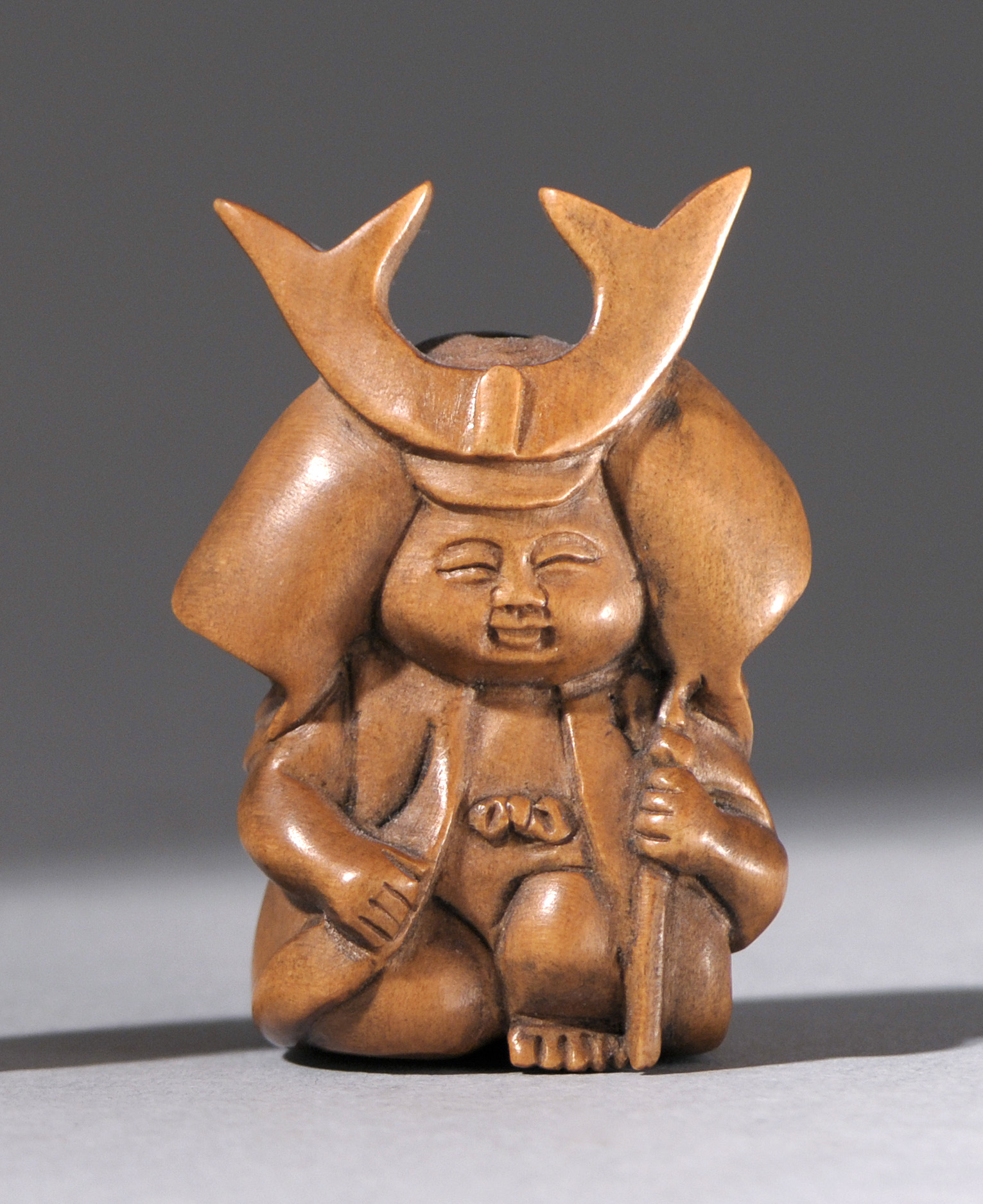 Appraisal: CARVED WOOD OJIME Meiji PeriodIn the form of a kneeling