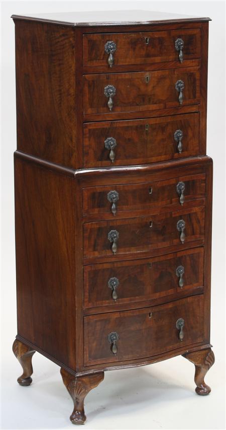 Appraisal: A walnut serpentine tallboy chest the moulded top over seven