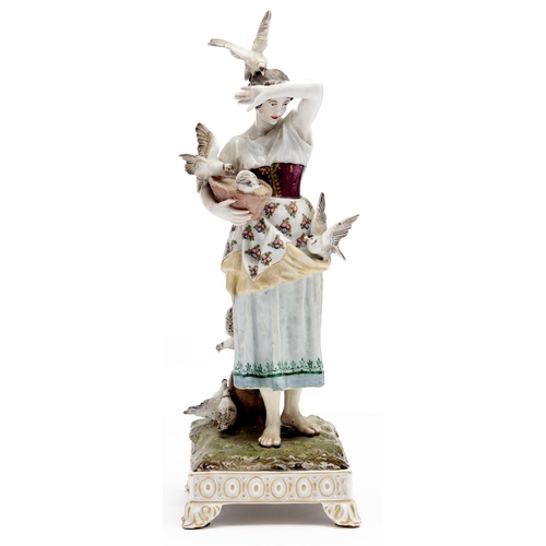 Appraisal: A German porcelain figure of a young women feeding pigeons