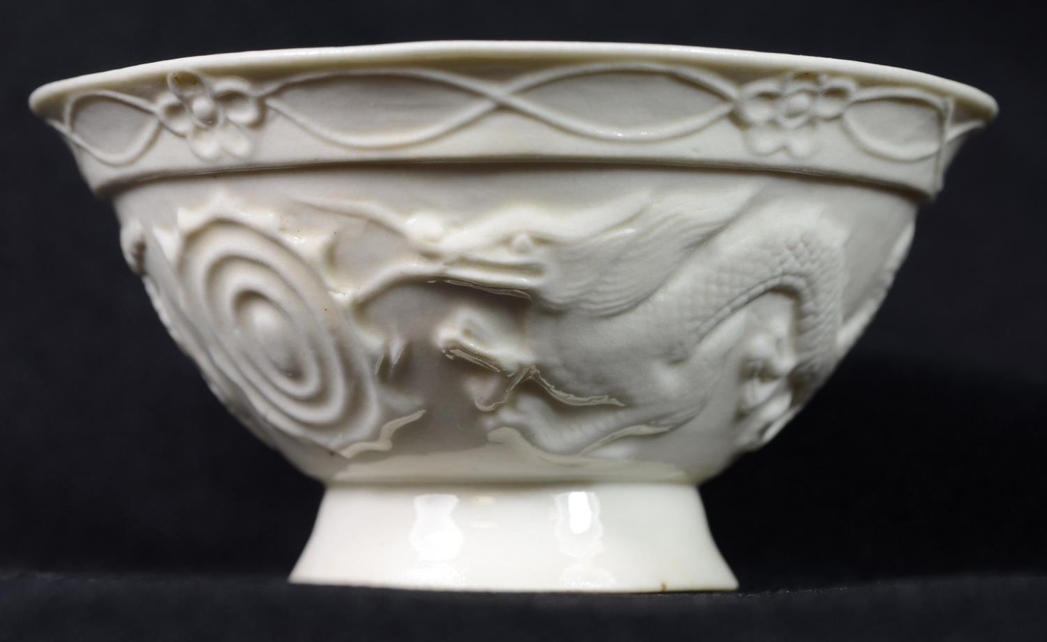 Appraisal: Early Chinese blanc de chine tea bowl with dragon decoration