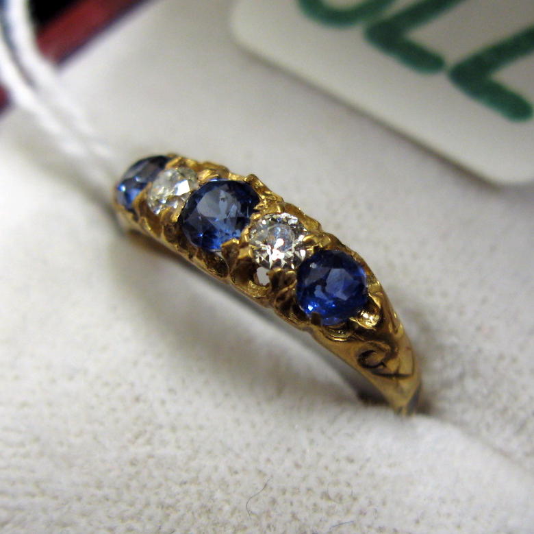 Appraisal: SAPPHIRE DIAMOND AND EIGHTEEN KARAT GOLD RING set with three