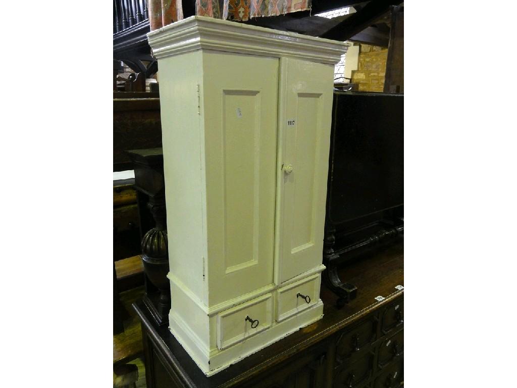 Appraisal: A small painted hanging wall cupboard enclosed by a pair