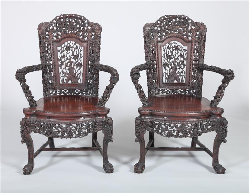 Appraisal: PAIR OF CHINESE CARVED HARDWOOD ARMCHAIRS Each with an arched