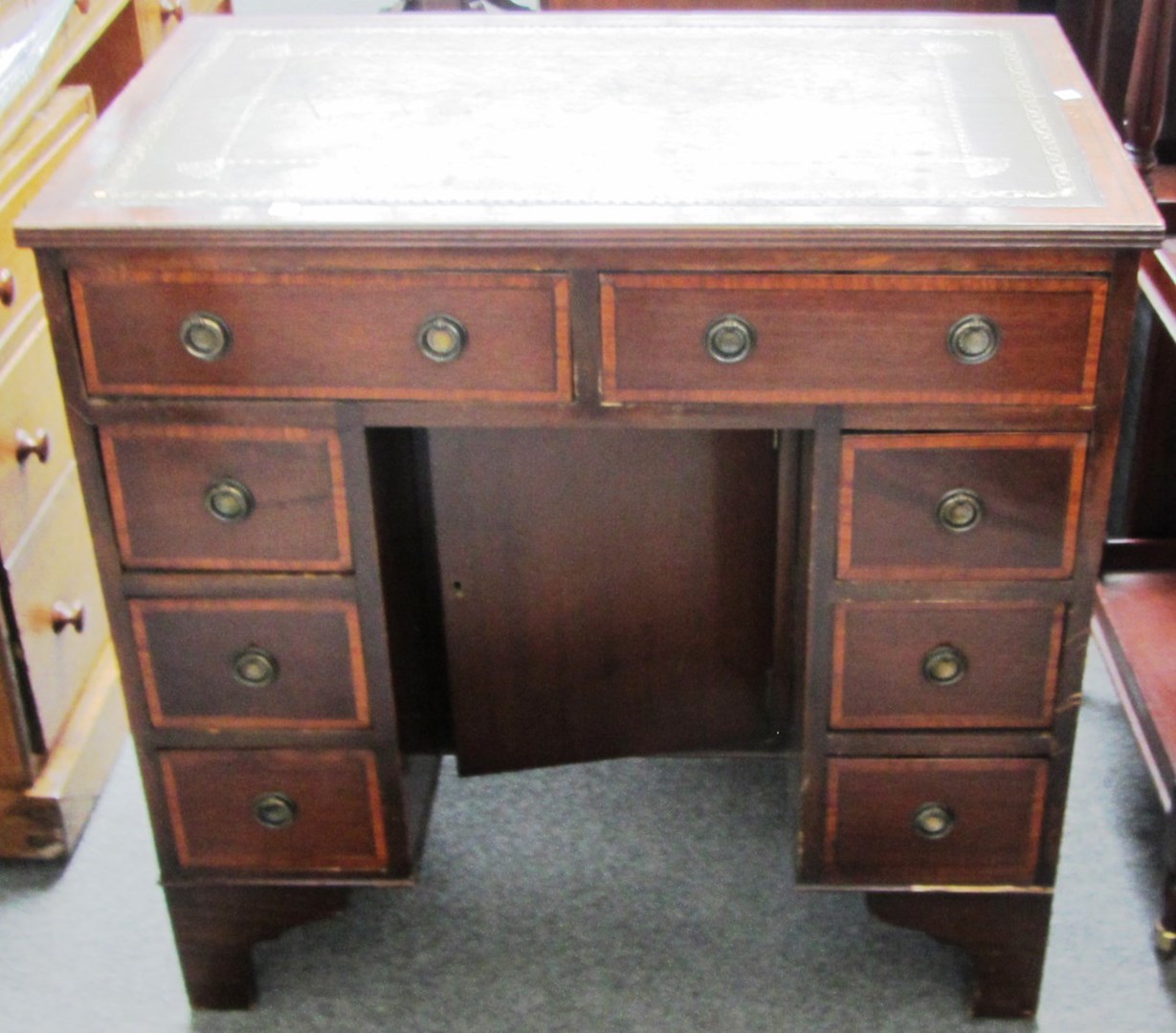 Appraisal: An th century style satinwood banded mahogany kneehole writing desk