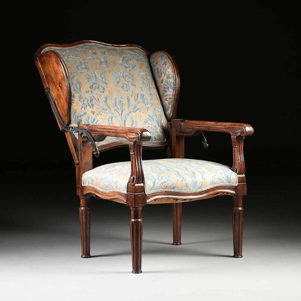 Appraisal: A LOUIS XVI UPHOLSTERED AND CARVED WALNUT ADJUSTABLE FAUTEUIL INCLINABLE