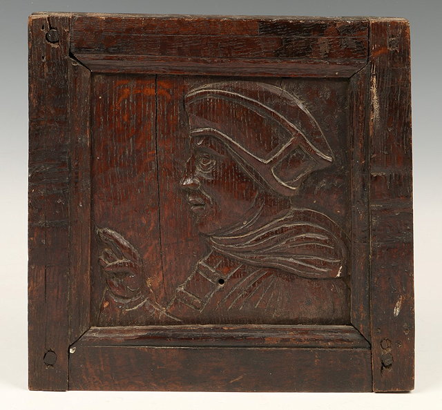 Appraisal: A TH CENTURY CARVED WOODEN PANEL of the head and