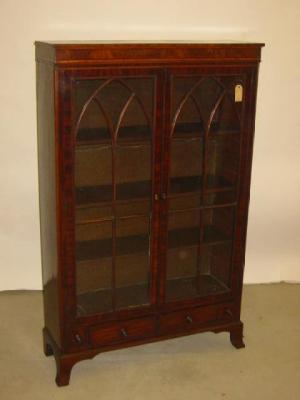 Appraisal: A MAHOGANY BOOKCASE crossbanded with ebony stringing two astragal glazed