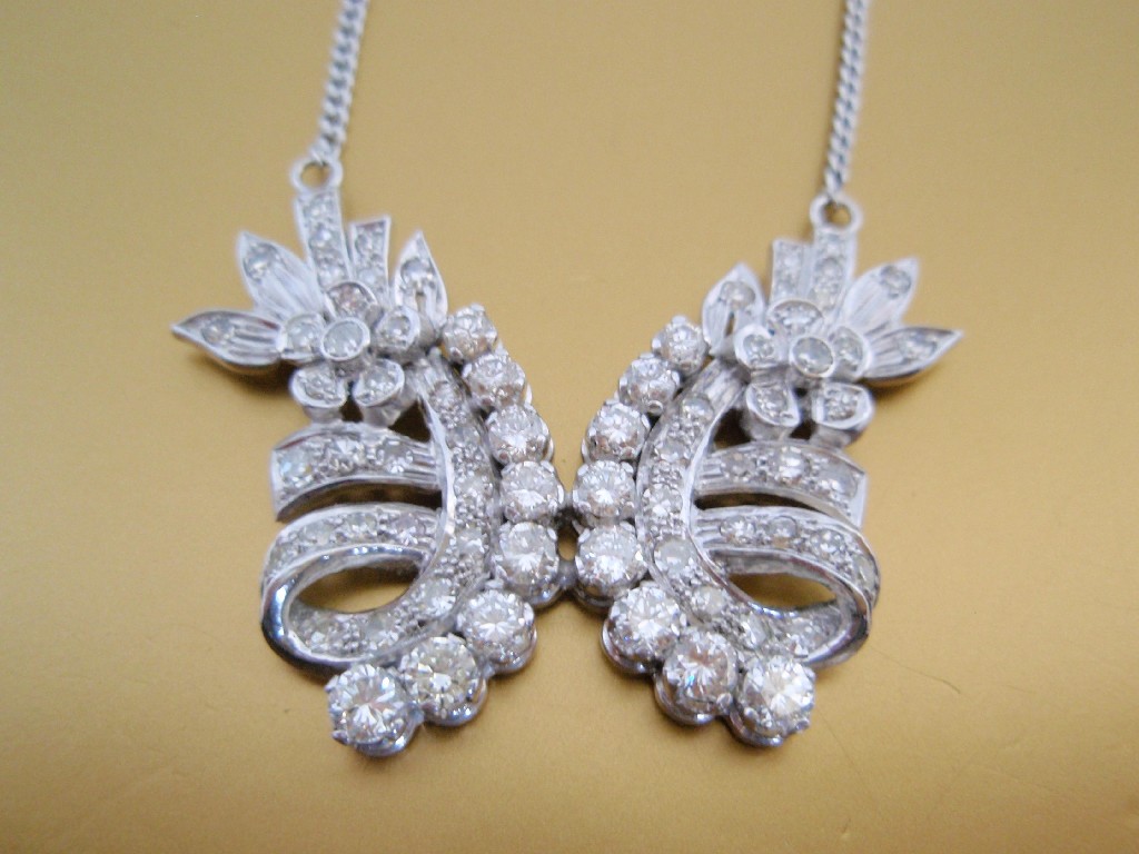 Appraisal: A style diamond set pendant of joined mirror image floral