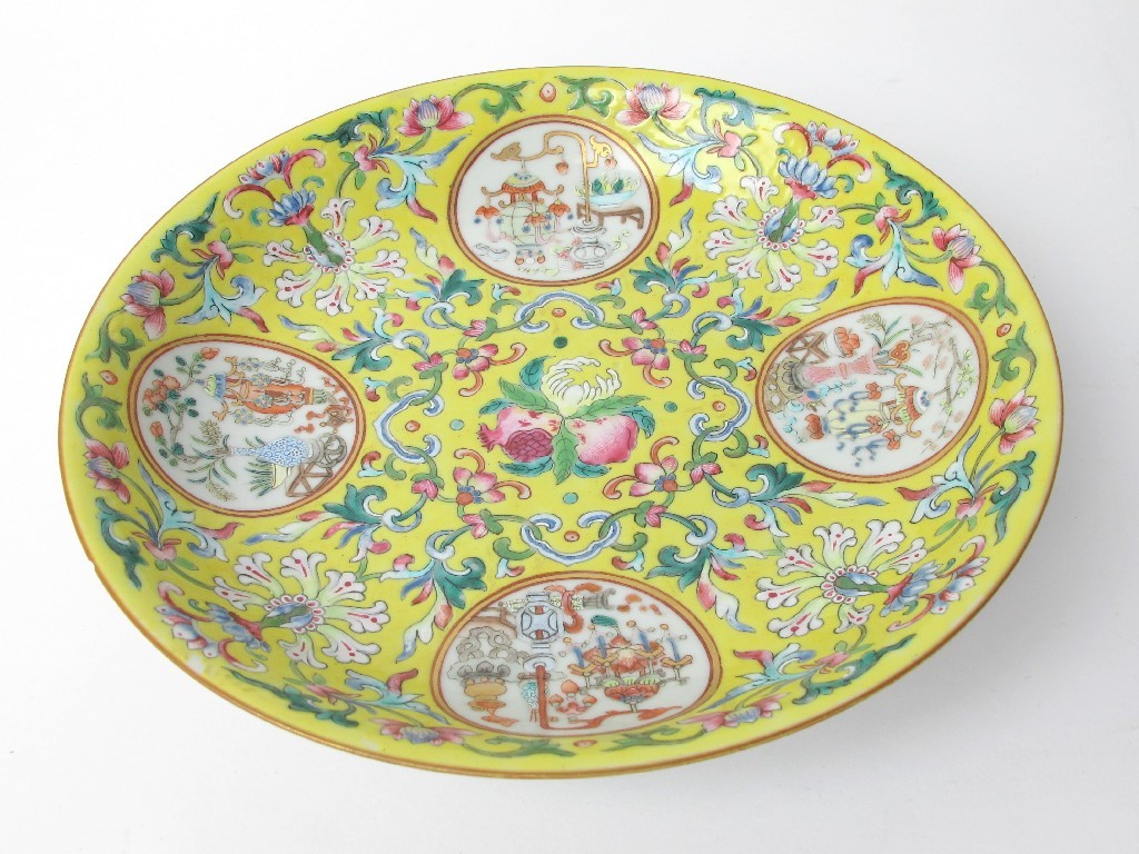 Appraisal: A Chinese yellow ground dish painted with four medallions containing