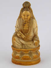 Appraisal: A Chinese ivory figure of Guanyin seated on a lotus