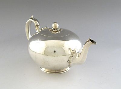 Appraisal: A Victorian silver teapot of circular form scroll handle the