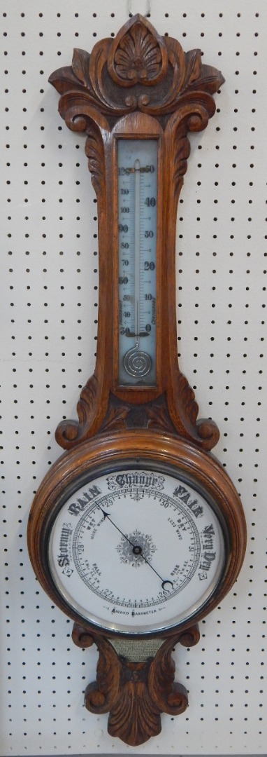 Appraisal: A Victorian oak cased barometer with thermometer foliate carved presentation