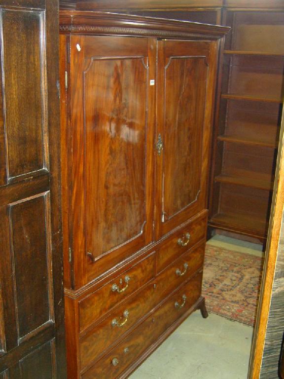 Appraisal: A Georgian mahogany linen press the front elevation enclosed by