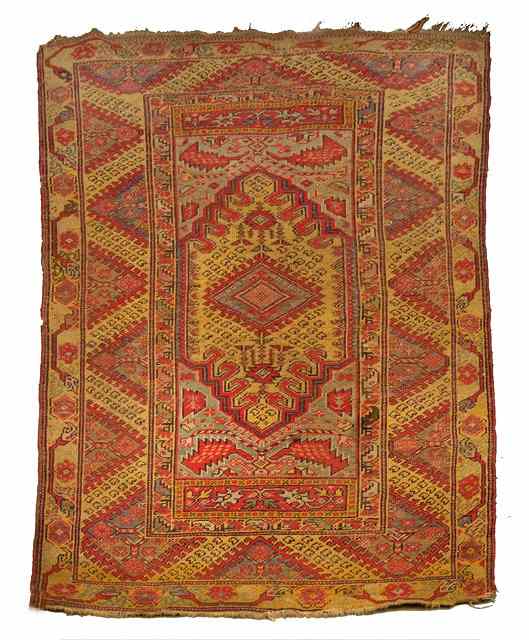 Appraisal: A MOROCCAN YELLOW GROUND RUG decorated a central medallion within