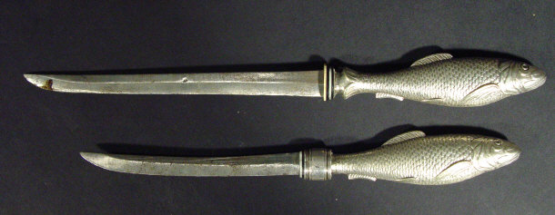 Appraisal: Pair of novelty paper knives the silver plated handles cast