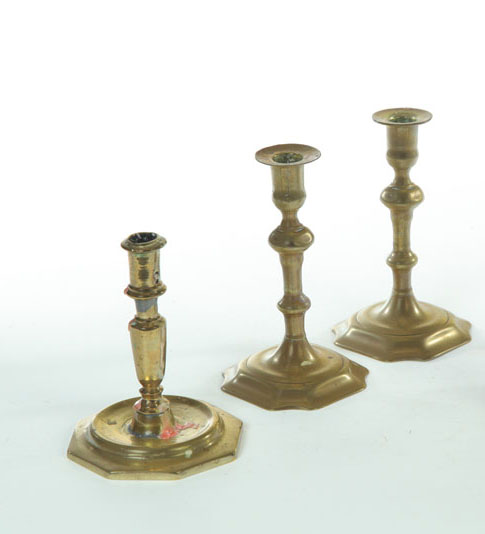 Appraisal: THREE BRASS CANDLESTICKS European mostly th century Pair with squared