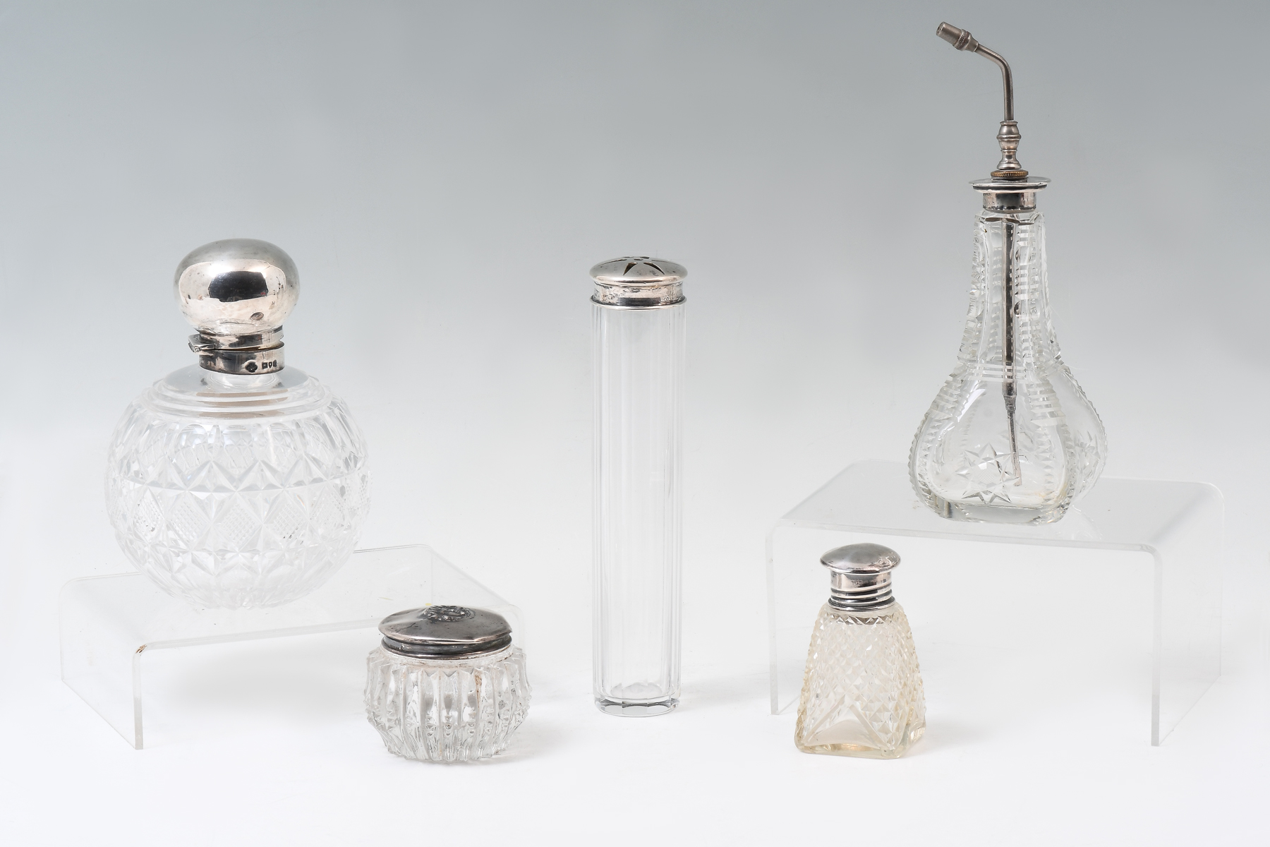 Appraisal: CUT GLASS VANITY BOTTLES WITH STERLING LIDS glass crystal dresser