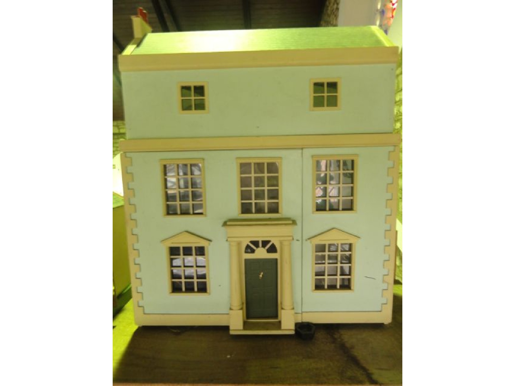 Appraisal: A model dolls house over three tiers the first and