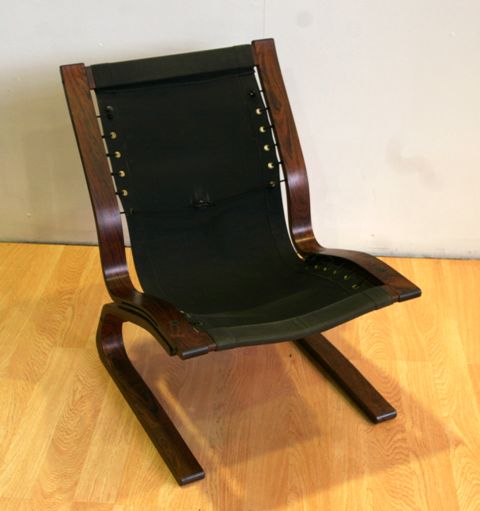 Appraisal: A mid- th century bent rosewood chair with strap canvas