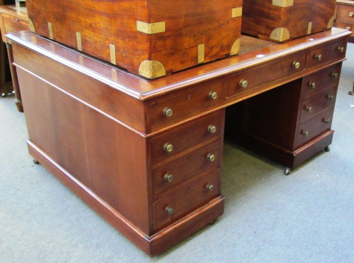 Appraisal: A th century mahogany partners desk with nine drawers about