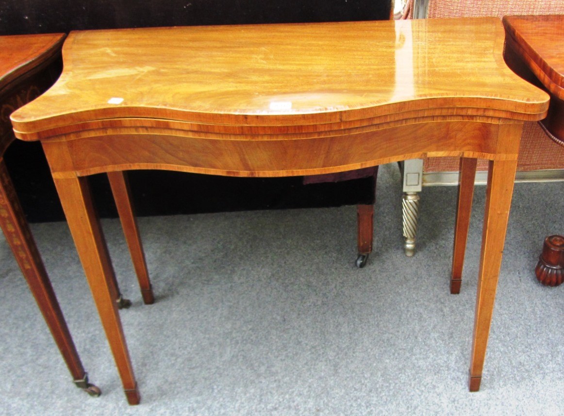 Appraisal: A George III kingwood banded mahogany serpentine card table on