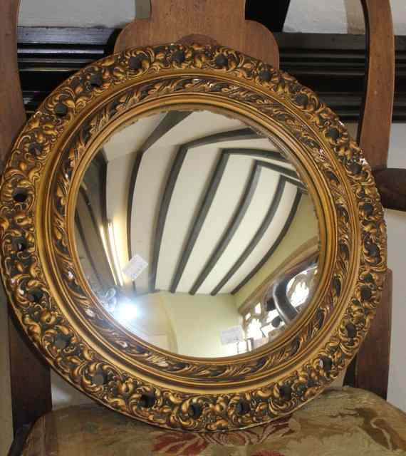 Appraisal: A CIRCULAR GILT PLASTER CONVEX MIRROR with leaf frame two