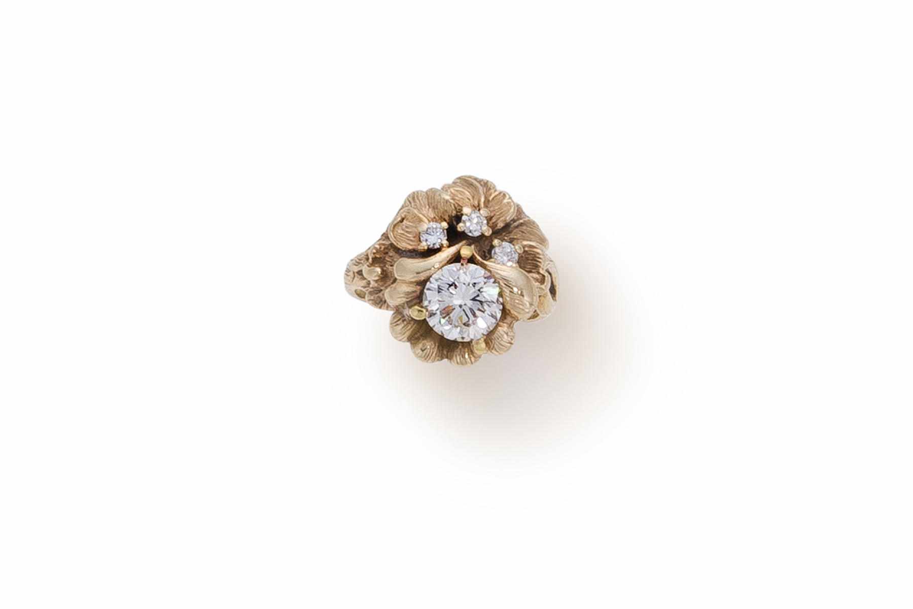 Appraisal: A diamond flower motif ring centering a round brilliant-cut diamond