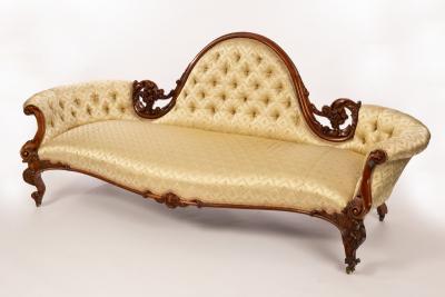 Appraisal: A Victorian sofa with central moulded arch upholstered back and