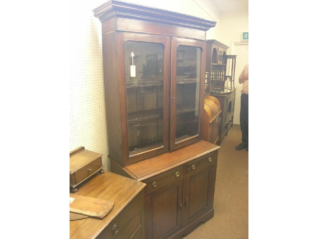 Appraisal: A mahogany tall bookcase modified Victorian glazed bookcase with three