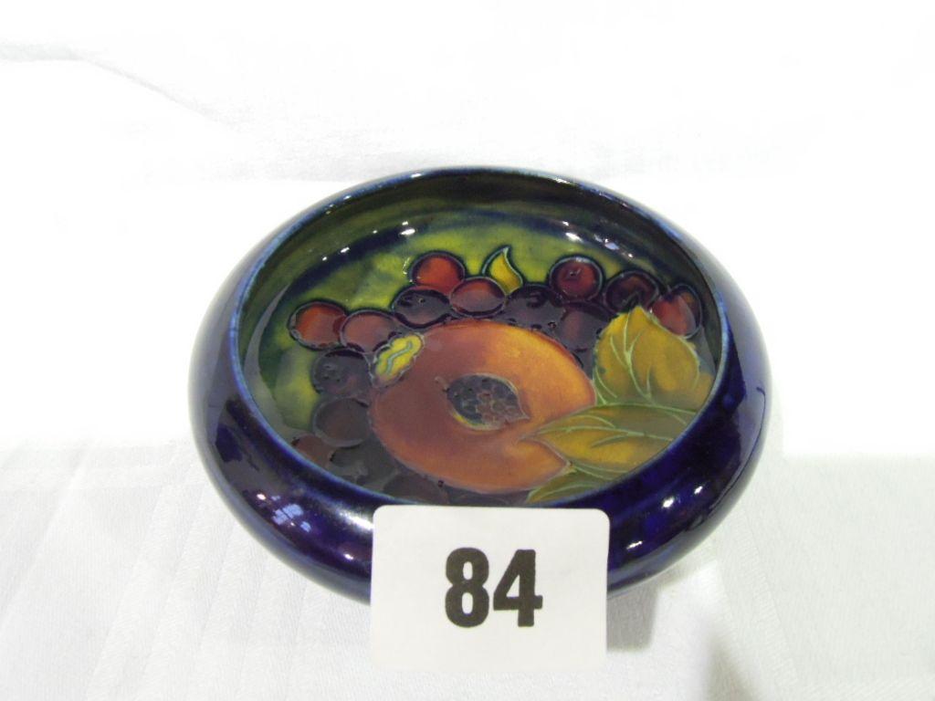 Appraisal: A Moorcroft pin dish decorated with fruit on a blue