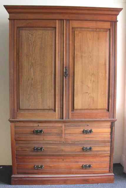 Appraisal: A late Victorian walnut linen press the panel doors enclosing