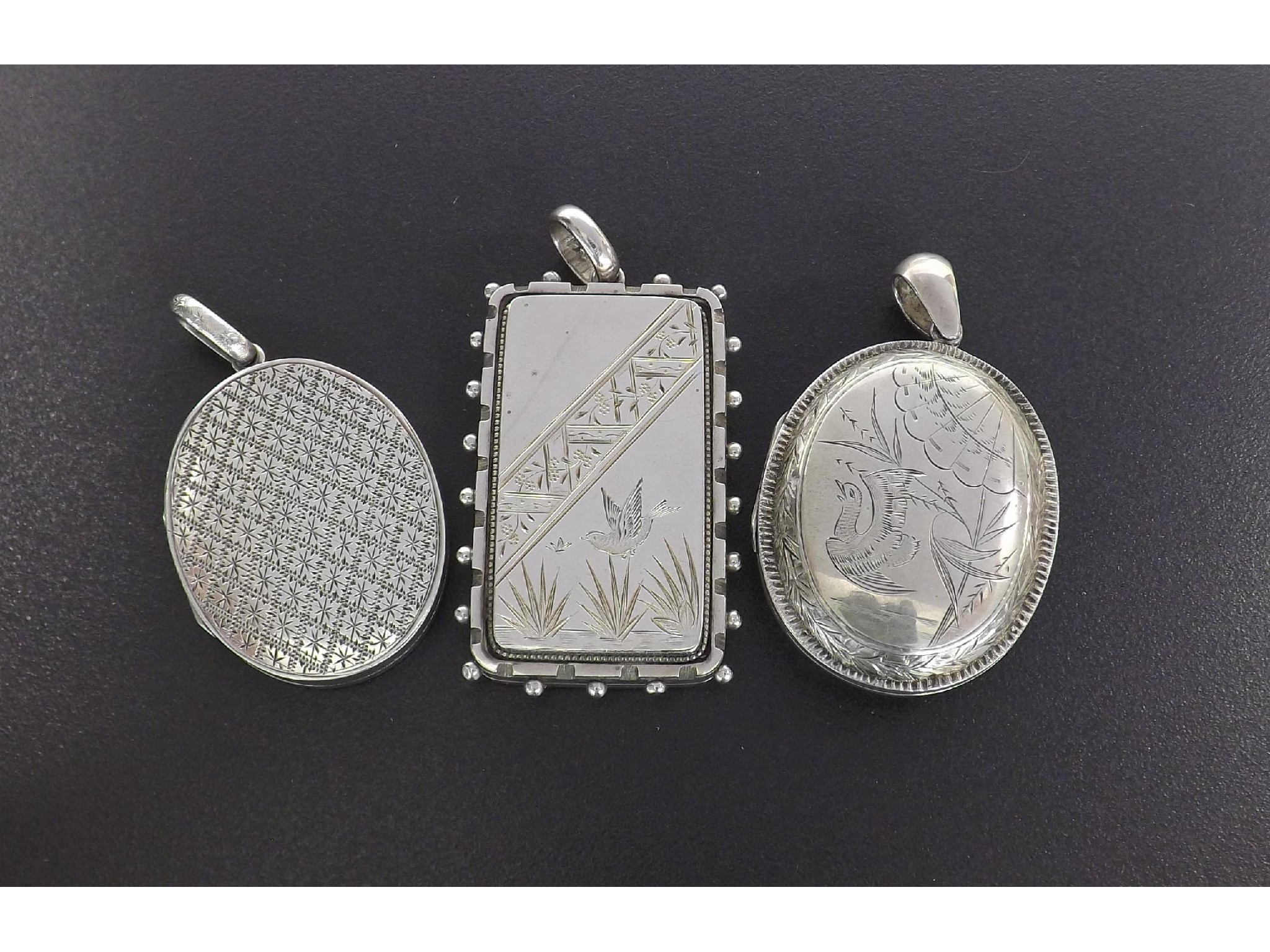 Appraisal: Three Victorian silver locket pendants including one rectangular example engraved