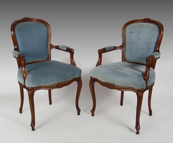 Appraisal: FRENCH STYLE BERGERE CHAIRS Matched pair carved walnut open arm