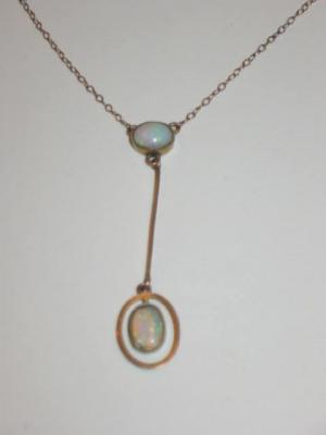 Appraisal: AN OPAL PENDANT comprising two oval cabochon opals set with