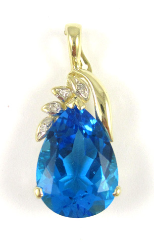 Appraisal: BLUE TOPAZ AND DIAMOND PENDANT k yellow gold set with